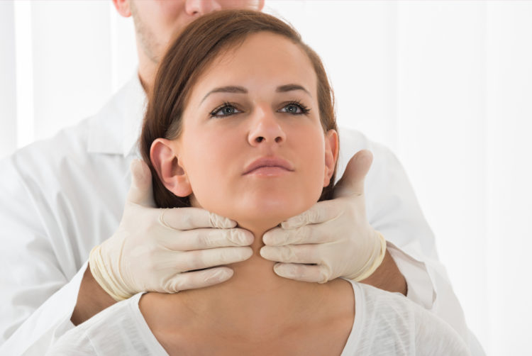 A Doctor Performing Physical Exam Palpation Of The Thyroid Gland